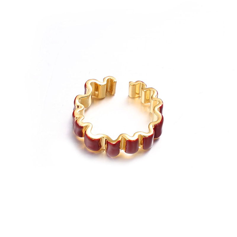 A gold-tone open band ring with a coloured enamel outer face, shown from above