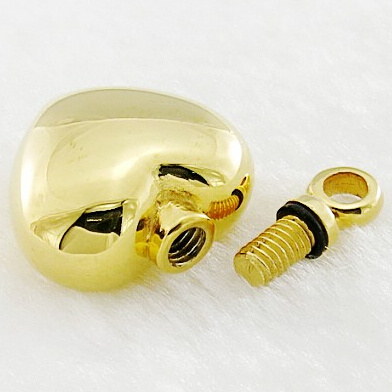 A gold-tone heart urn pendant shown opened, with the screw thread and rubber sealing ring visible